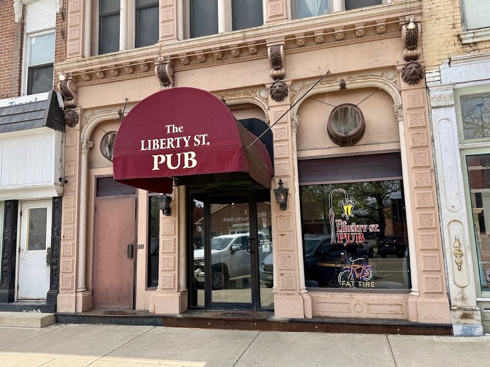 Cozy pub tables with beer glasses and bar seating.