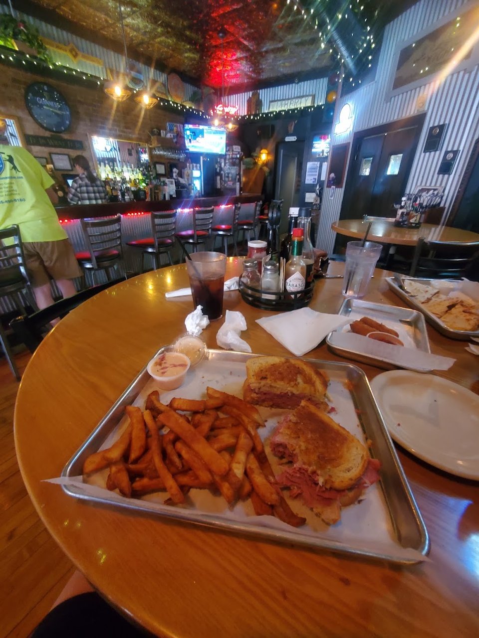 Printed pub menu with burgers, salads, and sandwiches.