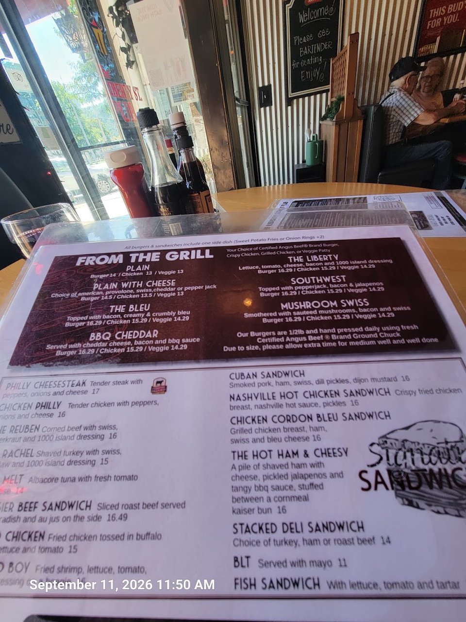 Printed pub menu with burgers, salads, and sandwiches.
